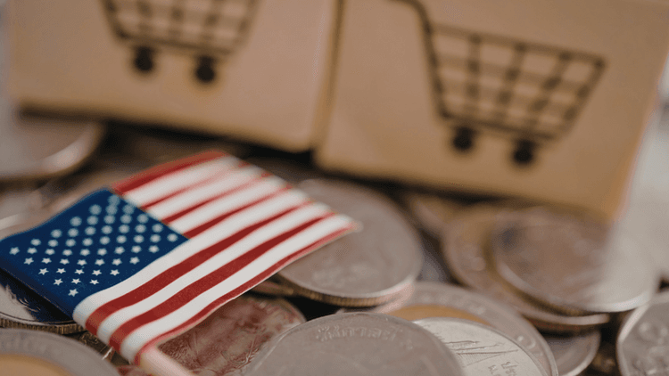 Coins with a small American flag and shopping cart icons representing U.S. trade and commerce.