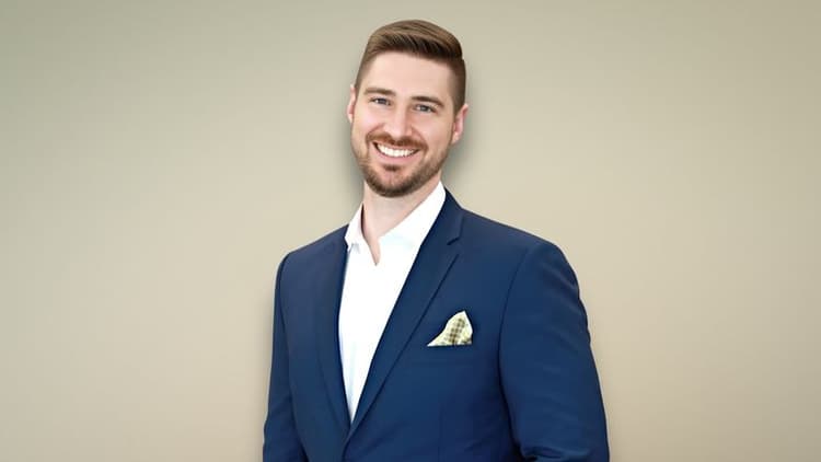 Patrick Melton, CEO of Inherited Home Helpers, smiling confidently in a blue suit with a pocket square.