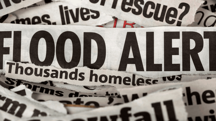 Flood alert headline displayed on torn newspaper clippings.