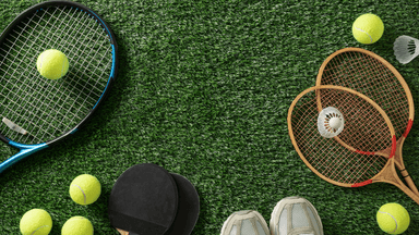 Tennis rackets, tennis balls, badminton rackets, and a shuttlecock on artificial grass