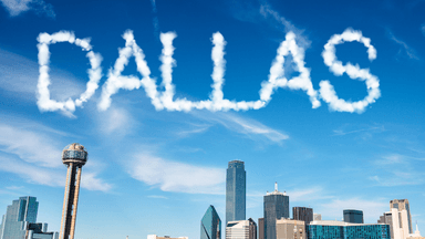 Skyline of Dallas with clouds spelling out the word "DALLAS" above the city.
