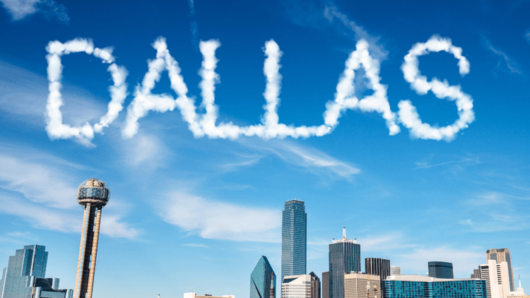 Skyline of Dallas with clouds spelling out the word "DALLAS" above the city.