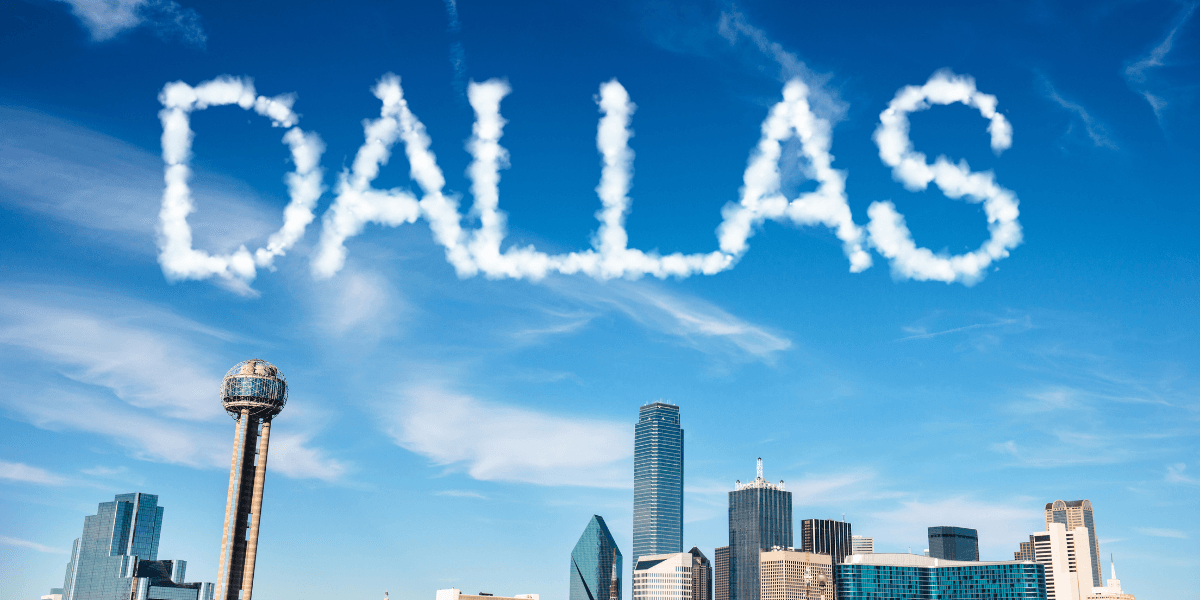 Skyline of Dallas with clouds spelling out the word "DALLAS" above the city.