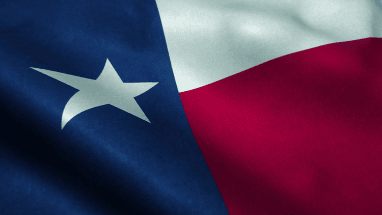 Close-up of the Texas state flag featuring blue, white, and red sections with a star