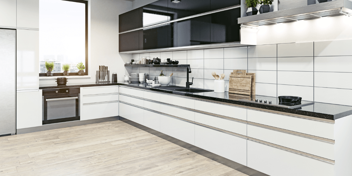 The kitchen features sleek modern design with custom cabinetry, a window with greenery view, and high-quality materials for a functional, stylish space.