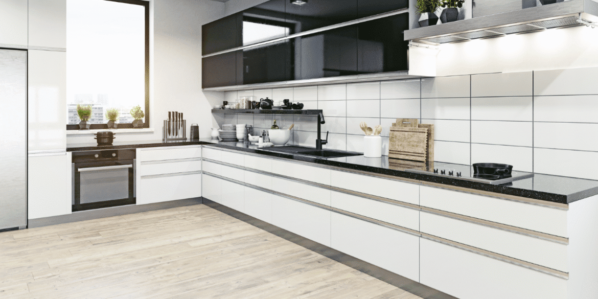 The kitchen features sleek modern design with custom cabinetry, a window with greenery view, and high-quality materials for a functional, stylish space.